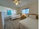 Guest bedroom with twin beds, a ceiling fan, and a sunny window at 6800 Placida Rd # 272, Englewood, FL 34224