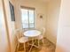 Bright breakfast nook with a small table, two chairs, and natural light from the window at 6800 Placida Rd # 272, Englewood, FL 34224