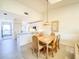 Dining area features a table for six that is adjacent to the kitchen with an open-concept design at 6800 Placida Rd # 272, Englewood, FL 34224
