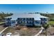 Exterior showcases the building's architecture with balconies and landscaping on a sunny day at 6800 Placida Rd # 272, Englewood, FL 34224