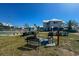 Grilling area with charcoal grills and picnic benches close to tennis courts at 6800 Placida Rd # 272, Englewood, FL 34224