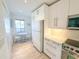 Bright kitchen with white cabinetry, stainless steel appliances, and a cozy breakfast nook at 6800 Placida Rd # 272, Englewood, FL 34224