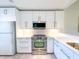 Modern kitchen with sleek white cabinets, stainless steel appliances, and ample counter space at 6800 Placida Rd # 272, Englewood, FL 34224