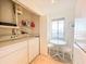 Practical laundry area with appliances, storage, and a bright view to the outside at 6800 Placida Rd # 272, Englewood, FL 34224