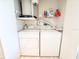 Functional laundry area with washer, dryer, and storage shelves for supplies at 6800 Placida Rd # 272, Englewood, FL 34224
