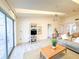 Spacious living room with a ceiling fan, sliding glass doors to the balcony, and a modern entertainment center at 6800 Placida Rd # 272, Englewood, FL 34224