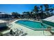 The community pool is surrounded by ample lounging chairs and overlooking a beautiful lake at 6800 Placida Rd # 272, Englewood, FL 34224