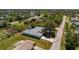 An aerial view of a home with lush landscaping and a large screened in patio at 7328 Yardley St, Englewood, FL 34224