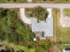 Beautiful aerial view of home with landscaped yard, circular driveway, and private screened-in pool at 7328 Yardley St, Englewood, FL 34224
