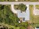 An aerial view showcasing a home with a pool, circular driveway, and lush trees at 7328 Yardley St, Englewood, FL 34224