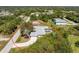 An aerial view of a home with a screened pool and circular driveway at 7328 Yardley St, Englewood, FL 34224