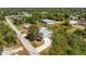 Aerial view of single-Gathering home with screened in pool, long driveway, and mature trees at 7328 Yardley St, Englewood, FL 34224