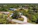 An aerial view of a single-story home with mature trees and lush landscaping at 7328 Yardley St, Englewood, FL 34224