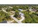 Aerial view of single-Gathering home with long driveway, and mature trees at 7328 Yardley St, Englewood, FL 34224