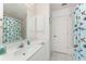 Bathroom featuring a large mirror, ample counter space, and a shower with a colorful fish curtain at 7328 Yardley St, Englewood, FL 34224