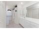 Bright bathroom featuring double vanity and window with flamingo patterned curtains at 7328 Yardley St, Englewood, FL 34224