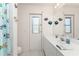 Bright bathroom features a white vanity, decorative fish accents, and a door to the exterior at 7328 Yardley St, Englewood, FL 34224