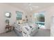 Nautical-themed bedroom with a ceiling fan and sliding glass door leading to the pool area at 7328 Yardley St, Englewood, FL 34224