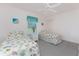 Bright bedroom features two twin beds with seashell-themed bedding and a ceiling fan at 7328 Yardley St, Englewood, FL 34224