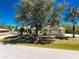 Charming single-story home with a well-manicured lawn, mature trees, and a two-car garage at 7328 Yardley St, Englewood, FL 34224
