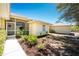 Well-maintained home exterior with lush landscaping, manicured lawn, and charming architectural details at 7328 Yardley St, Englewood, FL 34224