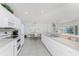Open concept kitchen with breakfast bar, modern appliances, and dining area at 7328 Yardley St, Englewood, FL 34224
