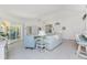 Open-concept living space featuring tile floors, modern furnishings, and great natural light at 7328 Yardley St, Englewood, FL 34224