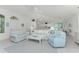 Spacious open-concept living area with vaulted ceilings, tile flooring and views to the kitchen at 7328 Yardley St, Englewood, FL 34224