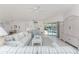 Bright, airy living room with comfortable furnishings, tile floors, and sliding glass doors to the pool at 7328 Yardley St, Englewood, FL 34224