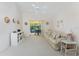 Cozy living room with vaulted ceilings and view to lanai at 7328 Yardley St, Englewood, FL 34224