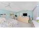 Bright main bedroom features blue walls, ceiling fans and ensuite bathroom at 7328 Yardley St, Englewood, FL 34224