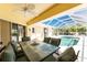 Covered patio with dining table and chairs offering views of the screened-in pool at 7328 Yardley St, Englewood, FL 34224