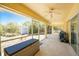 Enclosed patio with ceiling fan, outdoor furniture, and access to backyard shed at 7328 Yardley St, Englewood, FL 34224