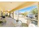Outdoor seating area with a view of the screened-in pool and backyard at 7328 Yardley St, Englewood, FL 34224