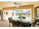Outdoor dining table with seating in covered and screened patio area, adjacent to pool at 7328 Yardley St, Englewood, FL 34224