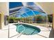 Beautiful kidney-shaped pool inside a screened enclosure, providing a private outdoor oasis at 7328 Yardley St, Englewood, FL 34224