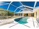 Relaxing screened-in pool area with lounge chairs and an outdoor dining space for entertaining at 7328 Yardley St, Englewood, FL 34224