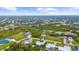 This aerial view showcases a neighborhood, with many trees and landscaping at 7339 Thomas St, Englewood, FL 34224