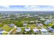 Aerial view showcasing the property in a neighborhood, with many trees and landscaping at 7339 Thomas St, Englewood, FL 34224