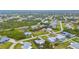 Aerial view showcasing a neighborhood with lush greenery, houses, and winding roads at 7339 Thomas St, Englewood, FL 34224