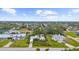 An aerial view of the property surrounded by green lawns and other houses at 7339 Thomas St, Englewood, FL 34224