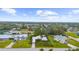 An aerial view of the property surrounded by green lawns and other houses at 7339 Thomas St, Englewood, FL 34224