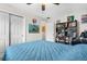 Comfortable bedroom with bright artwork, book shelves, and blue quilted bedding at 7339 Thomas St, Englewood, FL 34224
