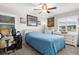 Bright bedroom featuring a ceiling fan, and a cozy blue quilted comforter at 7339 Thomas St, Englewood, FL 34224