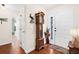 Entryway with wood floors, grandfather clock, and white front door at 7339 Thomas St, Englewood, FL 34224