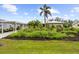 Charming home featuring lush landscaping and a beautiful palm tree at 7339 Thomas St, Englewood, FL 34224