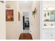 Hallway featuring wood floors leading to a bedroom and bathroom at 7339 Thomas St, Englewood, FL 34224