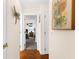 Hallway featuring wood floors and artwork leading to a bedroom at 7339 Thomas St, Englewood, FL 34224