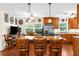 Bright kitchen features stainless steel appliances, wood cabinets, bar seating, and dining area with shuttered windows at 7339 Thomas St, Englewood, FL 34224