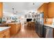 Kitchen with wood cabinets, stainless steel appliances, and open floor plan at 7339 Thomas St, Englewood, FL 34224